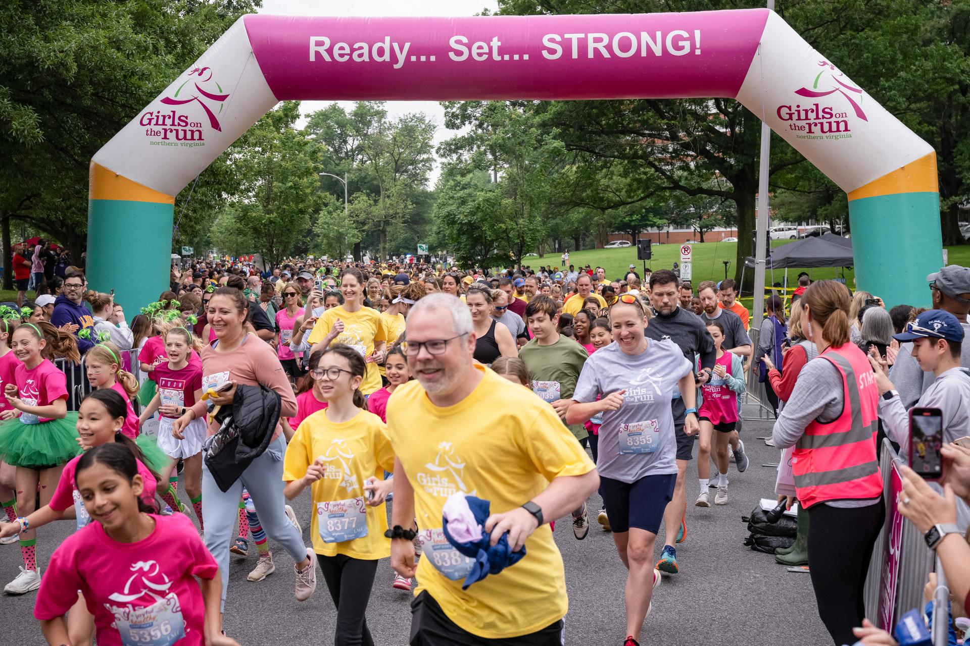 Girls on the Run participants crossing the start line of the 5K.