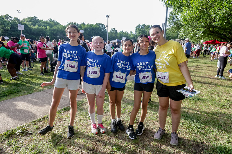 Four Heart & Sole participants standing with their coach and smiling.