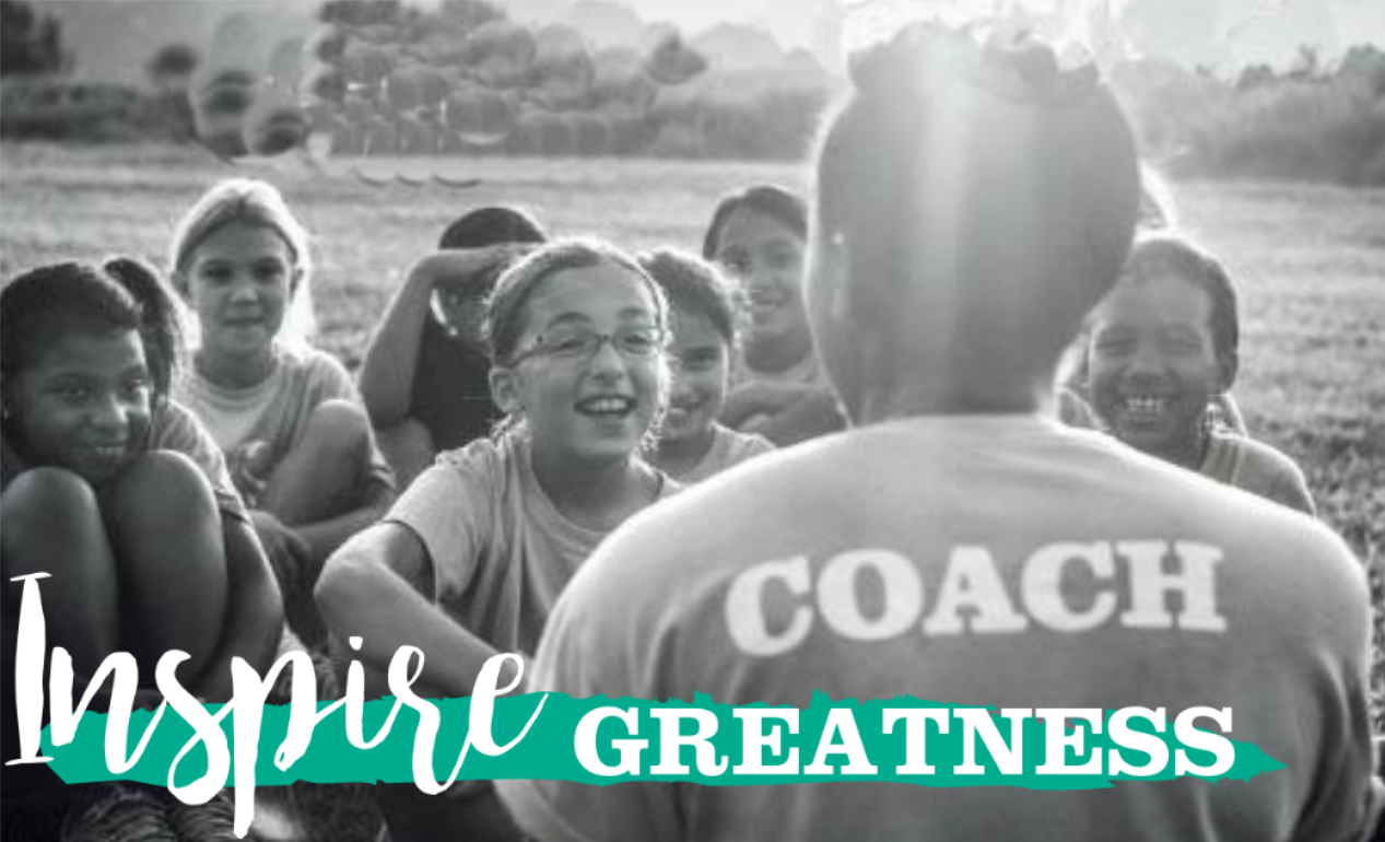 Image of a coach with their back to the camera and 